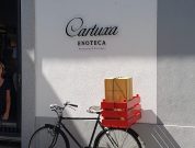black city bike with red box on the road
