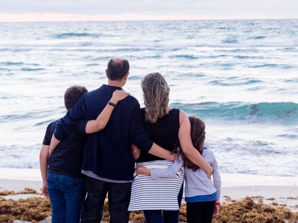 a family of four on a beach