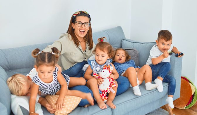 3 women sitting on gray couch